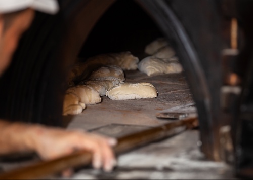 Bread oven with bread and cooking wood