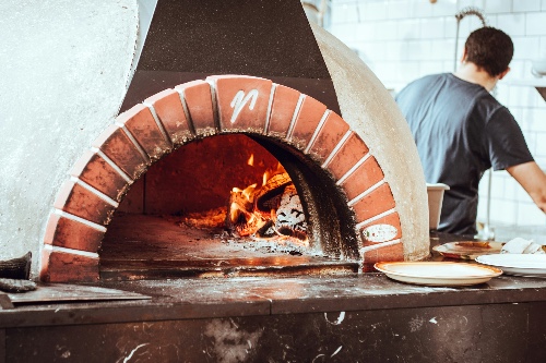 pizza oven showing kiln dried cooking wood